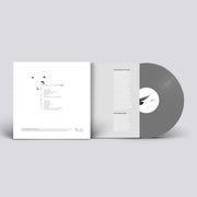A minimalistic gray vinyl record and gatefold packaging with black and white design elements.