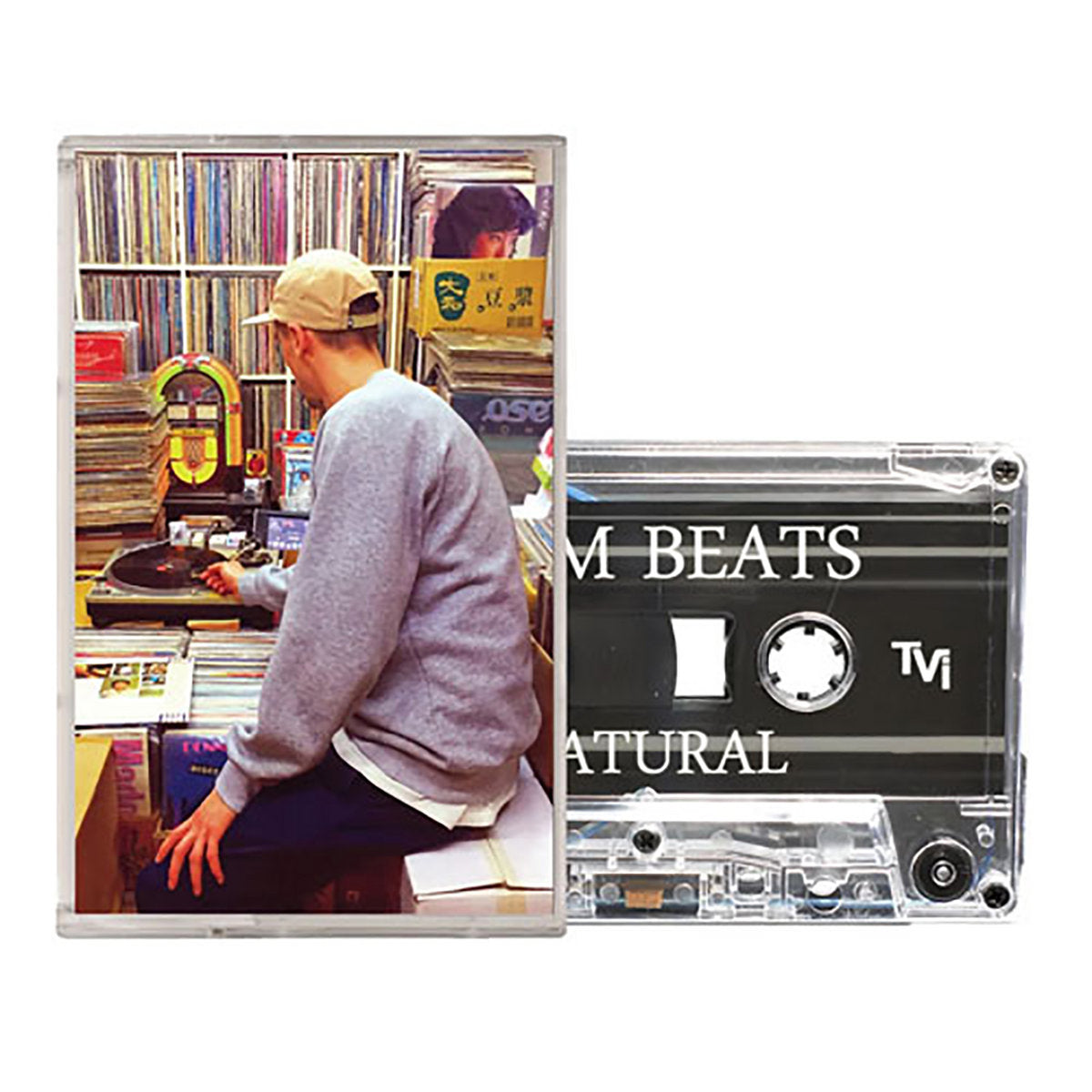Cassette tape and cover for Klim Beats' Natural album, featuring a photo of the producer digging through vinyl in a record-filled room.