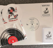 Reliable Sauce Volume One merch bundle displayed on a table, including a vinyl record, cassette tape, T-shirt, sticker pack, and album cover artwork.